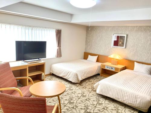 Tempat tidur dalam kamar di Hotel Shinanoji