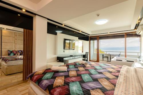 a bedroom with a large bed with a view of the ocean at Apartments BRAVO in Ohrid