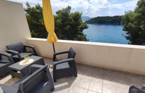 a balcony with chairs and a view of the water at Apartment Iva&Andro in Koločep