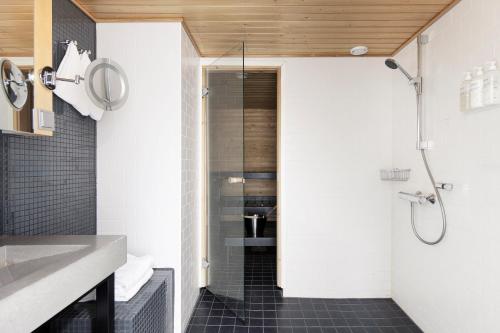 a bathroom with a shower and a sink at Original Sokos Hotel Villa Tampere in Tampere