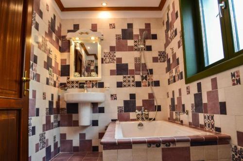 a bathroom with a tub and a sink and a mirror at Casa Comana Boutique Hotel in Bucharest