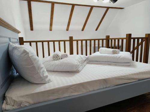 a bed with white sheets and pillows on it at Apartments Eibenthal in Eibenthal