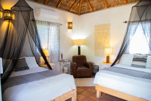 En eller flere senge i et værelse på Pure Baja Suites and Retreats - Single Rooms