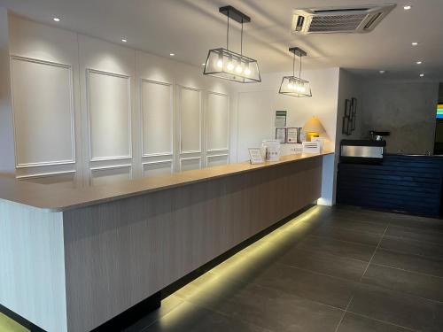 a restaurant with a counter with two lights above it at SiN LiEN HOTEL in Kluang