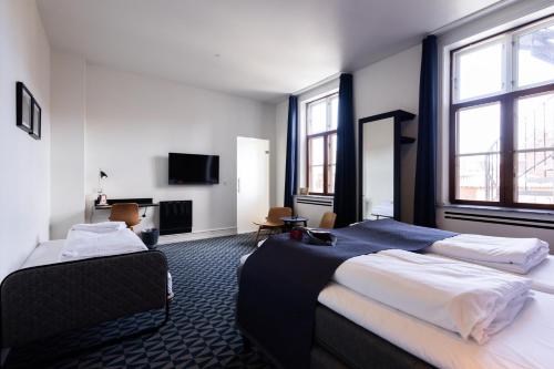 Кровать или кровати в номере Milling Hotel Ritz Aarhus City