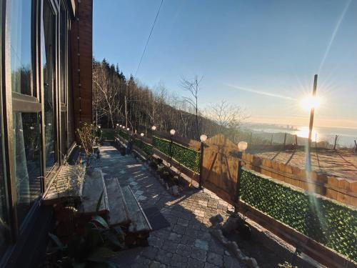 a row of benches sitting next to a building at Cottage "Sunset" in Batumi