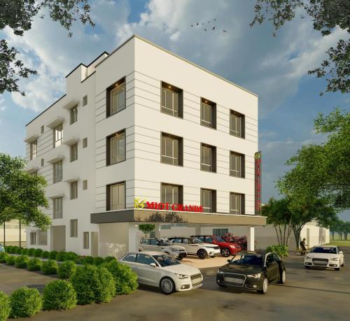 a rendering of a white building with cars parked in a parking lot at Mount Grande "formerly known as Miot Grande" in Chennai