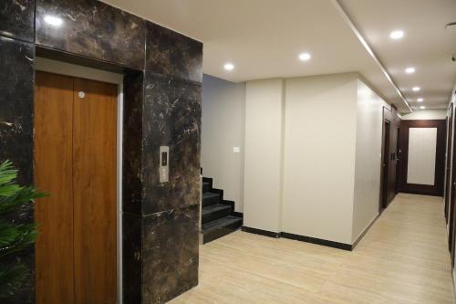 a hallway with a stair case and a hallway with a door at Mount Grande "formerly known as Miot Grande" in Chennai