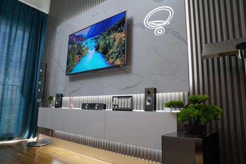 a living room with a tv on a wall at Diamond 72 apartment , Skopje City - Center, Diamond Residences, free parking in Skopje