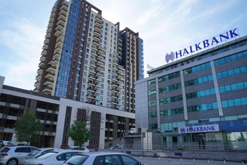 a parking lot with cars parked in front of tall buildings at Diamond 72 apartment , Skopje City - Center, Diamond Residences, free parking in Skopje