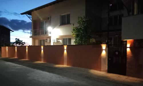 a fence with lights in front of a house at ViBo Guesthouse in Sapareva Banya