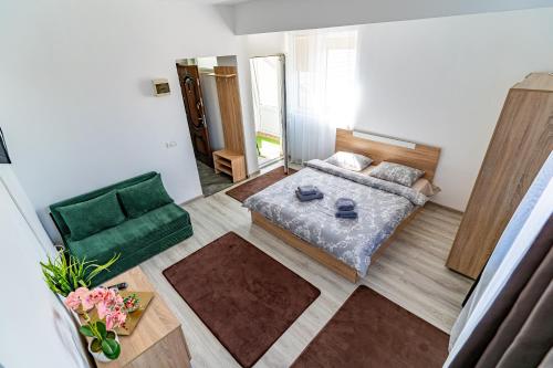 a living room with a bed and a couch at Casa DARYA-24h Check-in in Bucharest