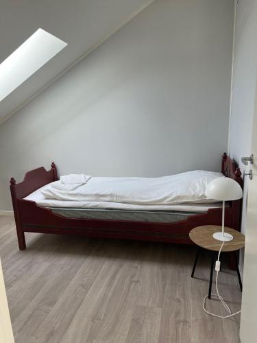 a bed in a room with a wooden floor at Mosjøen Romutleie EGEDESGATE 49 in Mosjøen