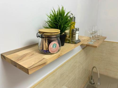 a jar on a wooden shelf in a kitchen at Apartament Fălticeni in Fălticeni