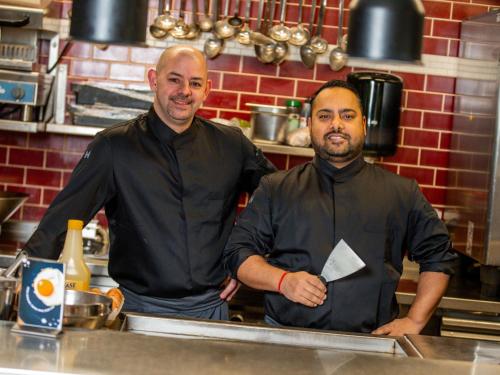 two men are standing in a kitchen at Novotel Rotterdam Brainpark in Rotterdam