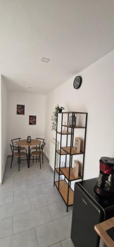 a dining room with a table and a shelf at Alex House in Făgăraş