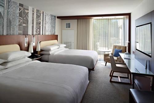 a hotel room with two beds and a desk at Marriott at the University of Dayton in Dayton