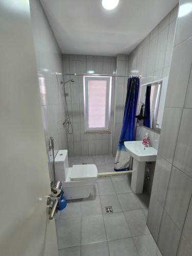 a bathroom with a toilet and a sink at Roxhensi 2 in Shëngjin