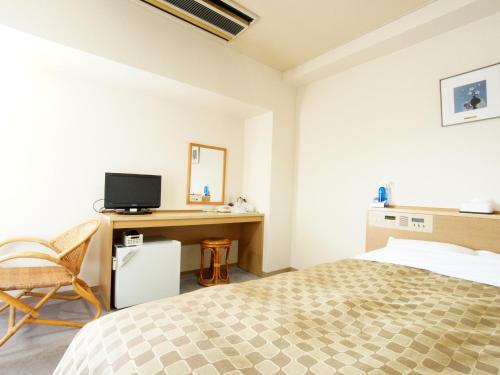 Giường trong phòng chung tại Hotel Trend Nagano