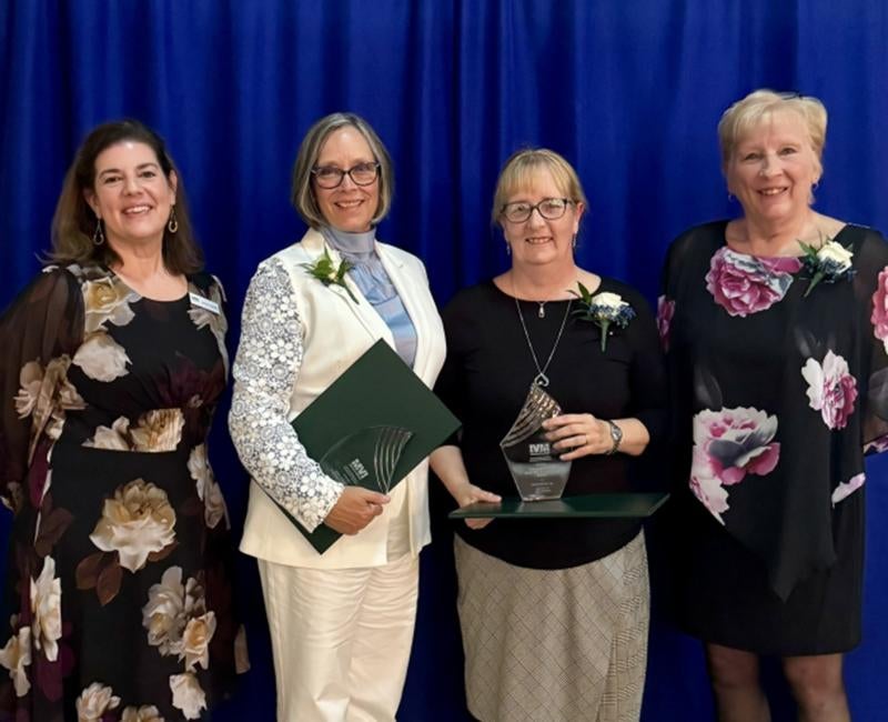 Dawna Cerney (second from left) and Susan Lucas (second from right) pose with others during their SEED award recognition for the Swissvale project.