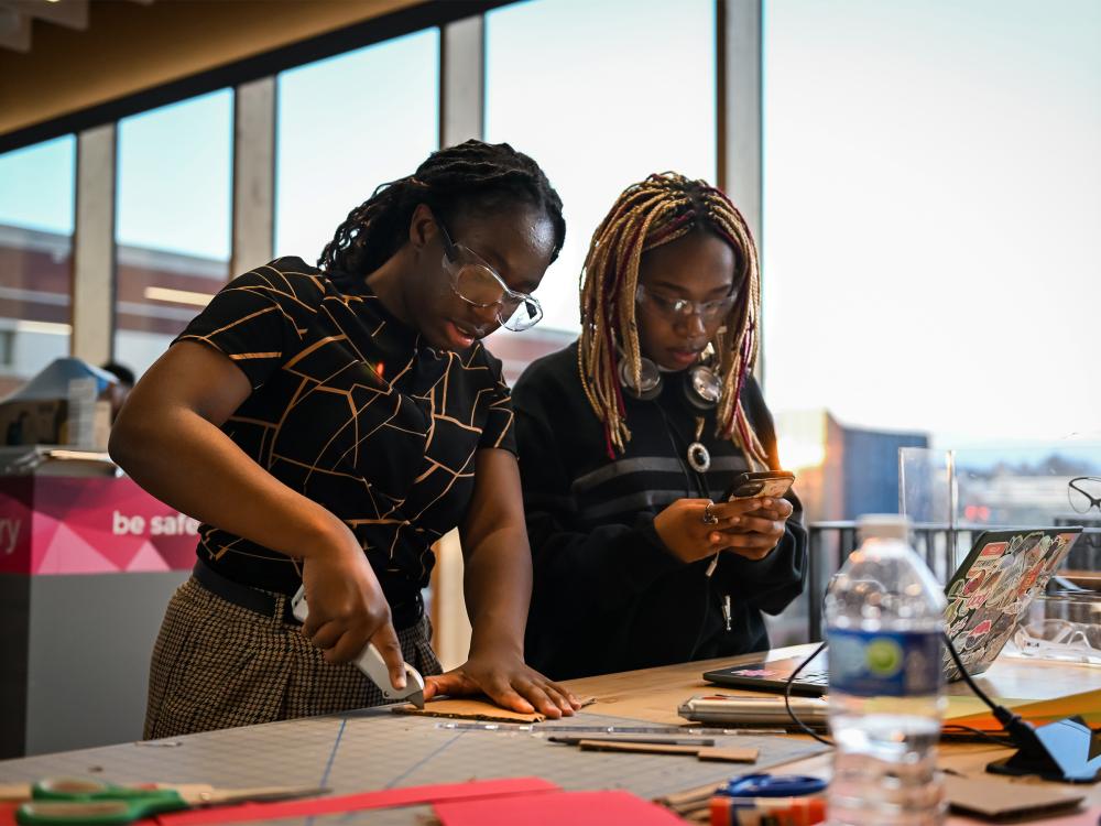 Two students collaborate on an engineering project.