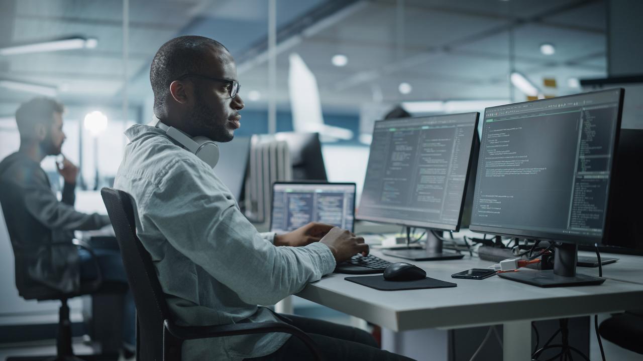 A male sitting a desk