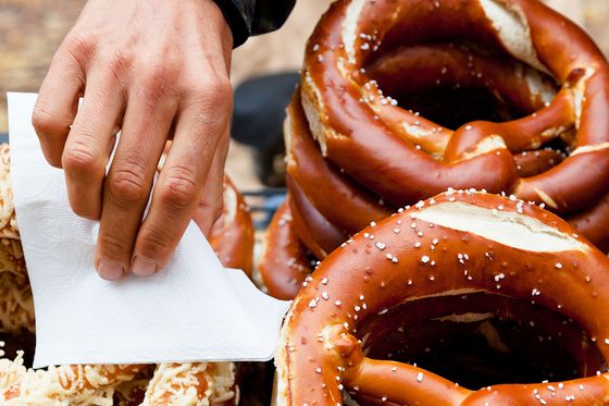 hand grabbing german pretzel