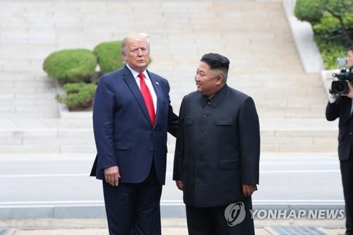 In this file photo, U.S. President Donald Trump (L) talks with North Korean leader Kim Jong-un after crossing the Military Demarcation Line onto the North's side at the truce village of Panmunjom in the Demilitarized Zone, which separates the two Koreas, on June 30, 2019. Trump became the first sitting U.S. president to step onto North Korean soil. (Yonhap)