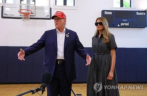 Former U.S. President Donald Trump, accompanied by former first lady Melania Trump, speaks to reporters as he votes at Mandel Recreation Center on Election Day in Palm Beach, Florida on Nov. 5, 2024 in this photo released by Reuters. (Yonhap)