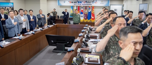 Defense Minister Shin Won-sik (C) and senior defense and military officials salute as they attend a meeting of top military commanders on July 9, 2024, in this photo provided by Shin's office. (PHOTO NOT FOR SALE) (Yonhap)