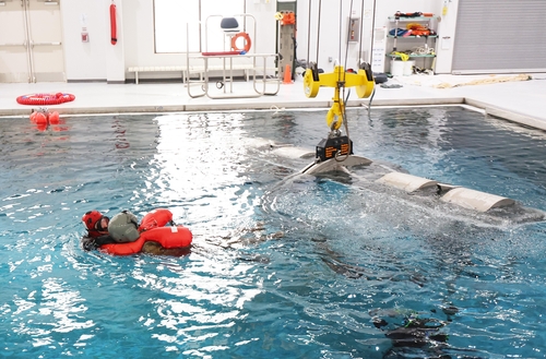 Divers rescue a helicopter pilot during an underwater egress training held at Vandal Training Center in Camp Humphreys in Pyeongtaek on April 6, 2024. (Yonhap) 
