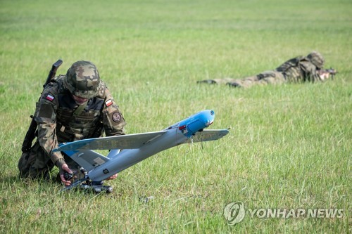 This file EPA photo, taken Sept. 26, 2022, shows a Polish soldier operating an unmanned aerial vehicle in Inowroclaw, Poland. (Yonhap)