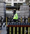 Police beef up security at the main gate of the Constitutional Court in Seoul on Dec. 18, 2024, as the court reviews the parliamentary impeachment of President Yoon Suk Yul over his short-lived declaration of martial law. (Yonhap)