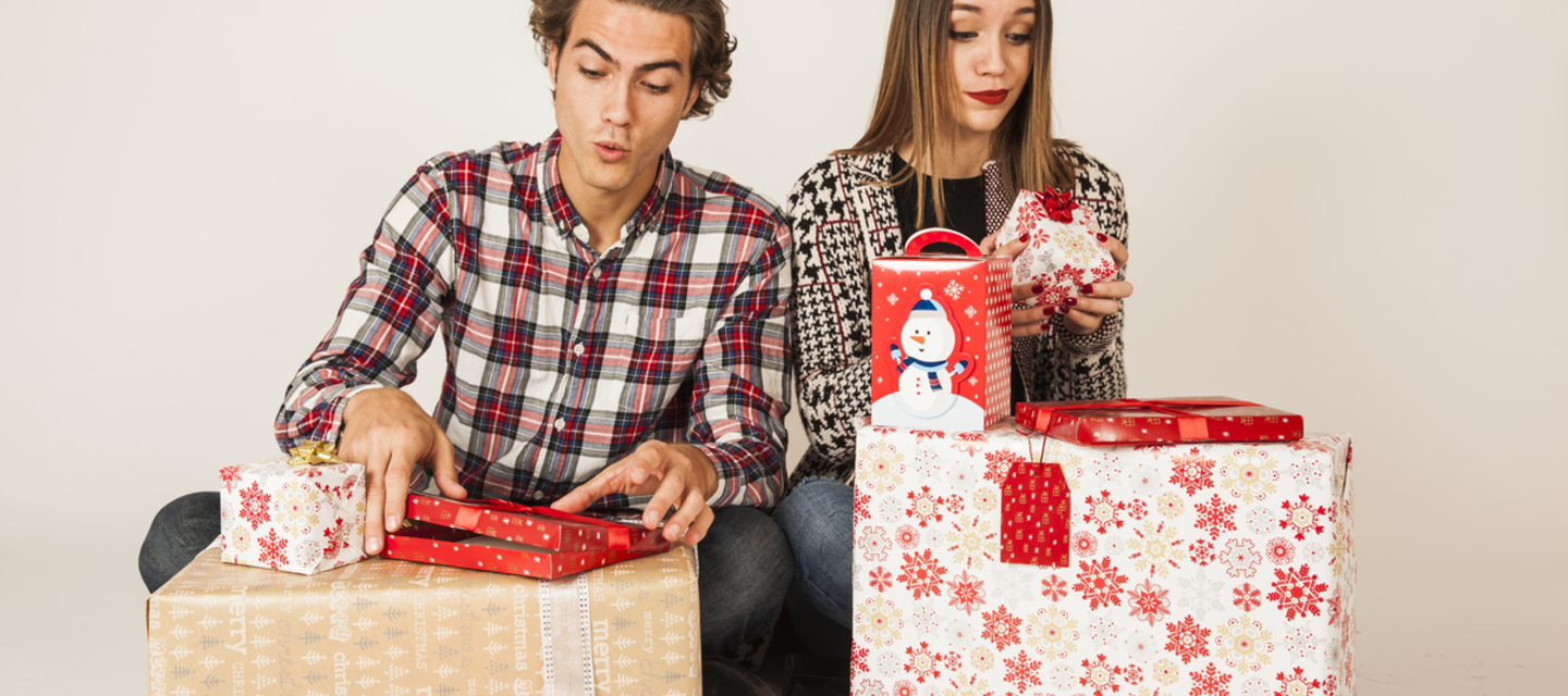 Man and woman opening Christmas presents