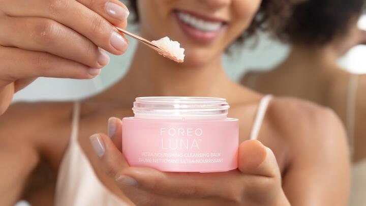 Closeup of a female model holding FOREO LUNA Ultra-Nourishing Cleansing Balm