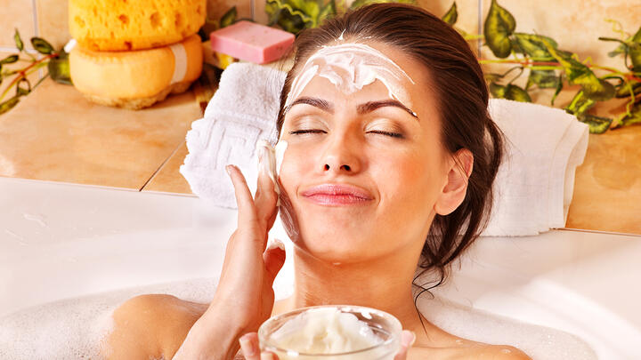 Woman on a facial treatment with moisturizer on her face