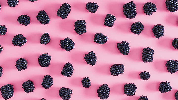 Blackberries on a pink surface