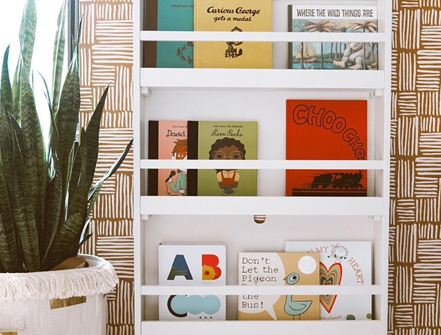 Magazine holders with books in a room with plants