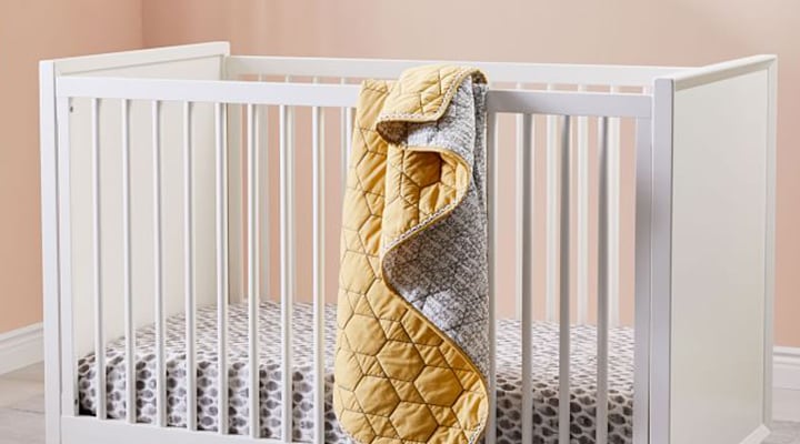 Yellow honeycomb quit hanging over crib