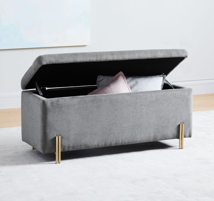 Gray upholstered storage bench.