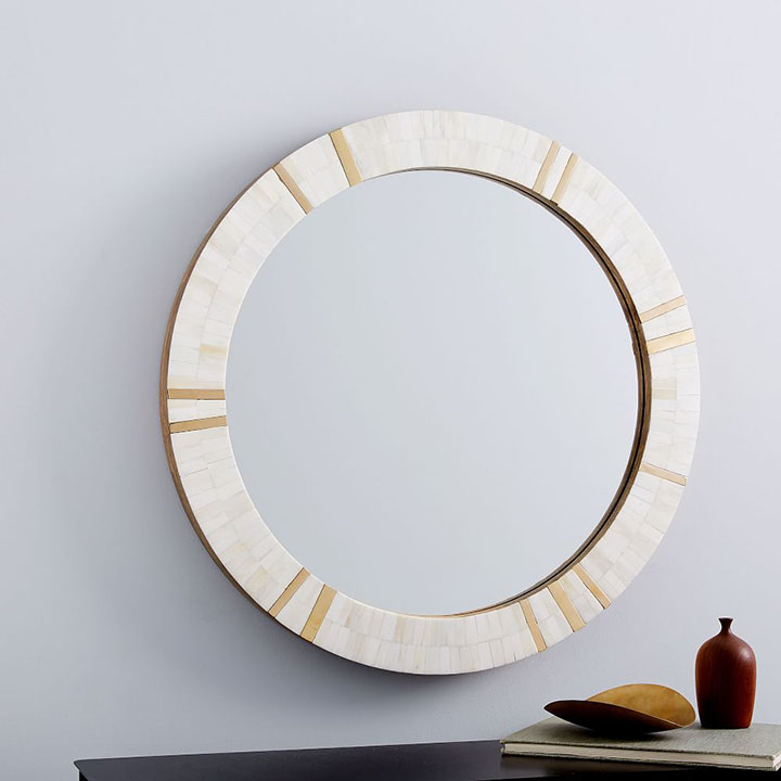 Textured brass bone framed round mirror.