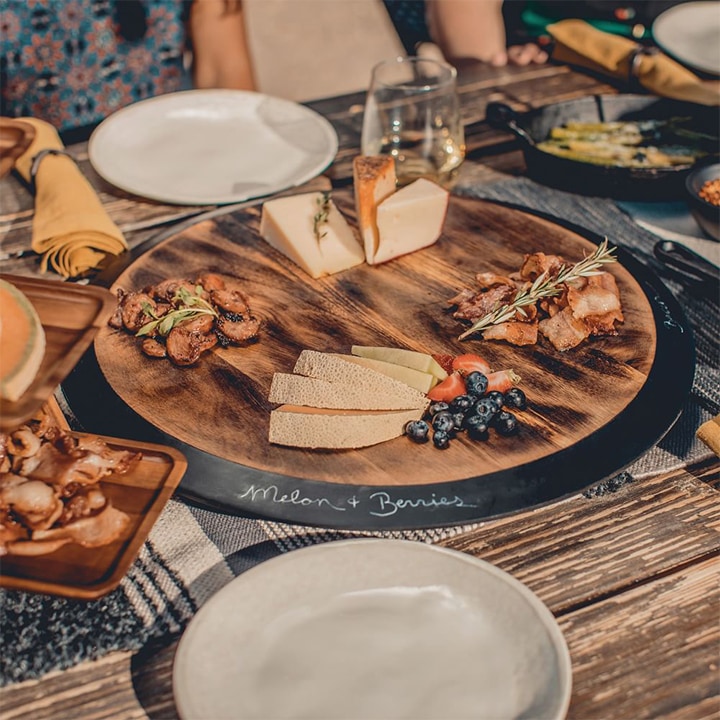 lazy susan serving tray with fruits and cheeses.