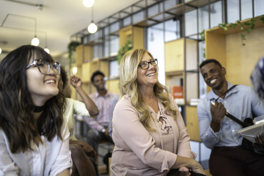 Audience laughing at business convention and presentation