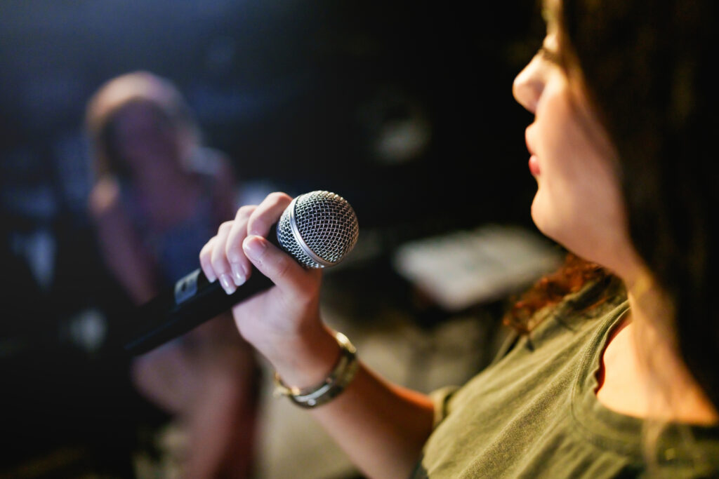 A woman performing arts on stage.