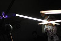 Little girl and father making arcs with tesla coil