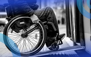 A person in a wheelchair using a ramp to board a bus.