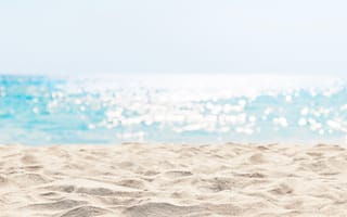 Panorama of a white sand beach and turquoise water.