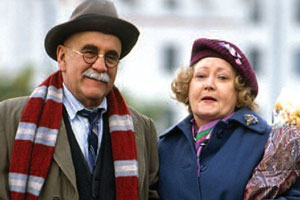 In Sickness & In Health. Image shows from L to R: Alf Garnett (Warren Mitchell), Mrs Hollingbery (Carmel McSharry). Copyright: BBC