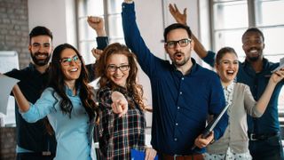 Employees cheering in an office space