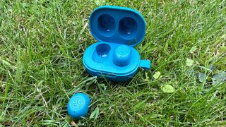 The JLab JBuds Mini on a patch of grass